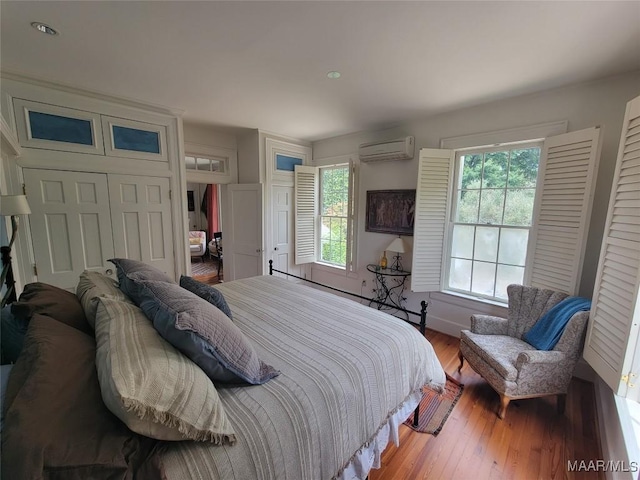 835 Park Ave, Montgomery, AL 36106 - bedroom with a wall mounted AC, a closet, and wood-type flooring