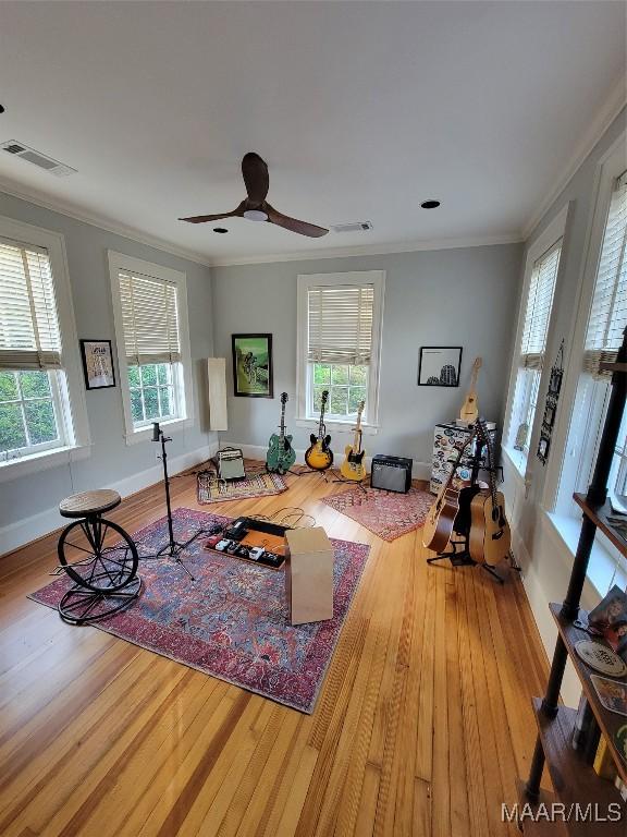835 Park Ave, Montgomery, AL 36106 - exercise room featuring wood-type flooring, a wealth of natural light, and ornamental molding