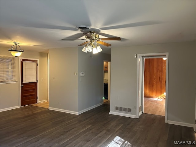 empty room featuring dark hardwood / wood-style floors and ceiling fan