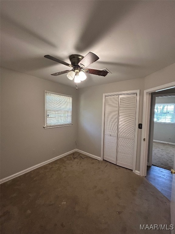 unfurnished bedroom featuring carpet, a closet, and ceiling fan