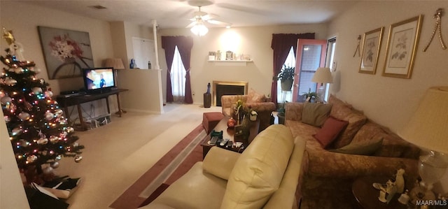 carpeted living room with ceiling fan