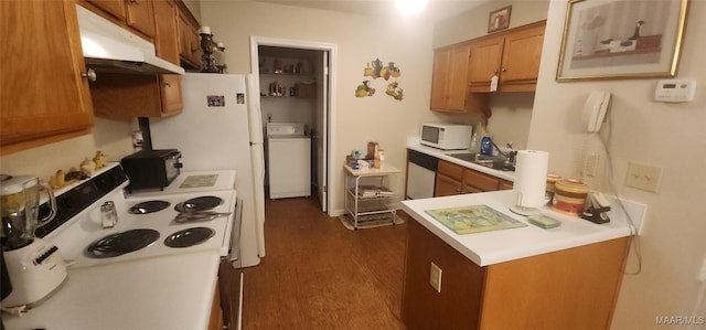 kitchen with washer / dryer, white appliances, dark wood-type flooring, and sink