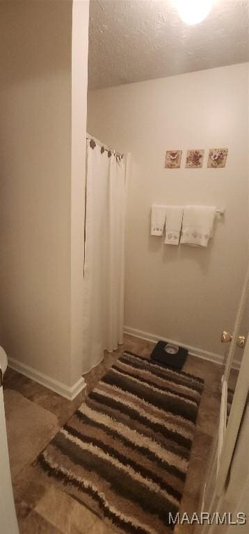 bathroom with a textured ceiling