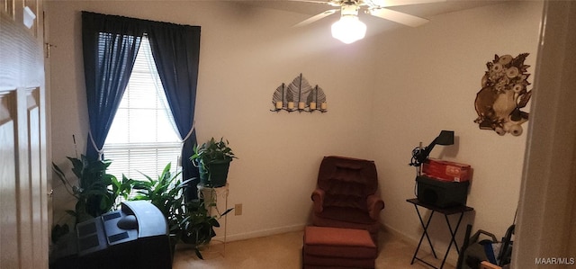 living area with ceiling fan and carpet floors