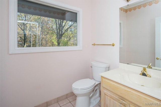 bathroom featuring tile patterned floors, vanity, and toilet