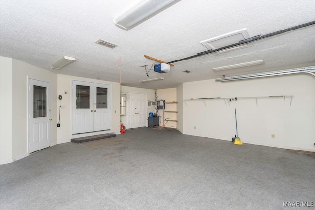 garage featuring french doors and a garage door opener