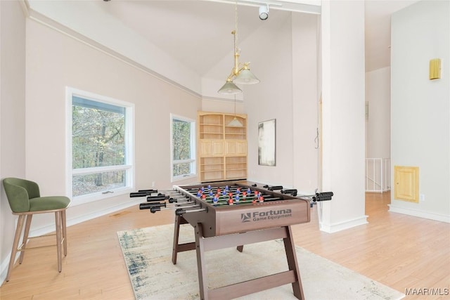 game room featuring wood-type flooring and vaulted ceiling