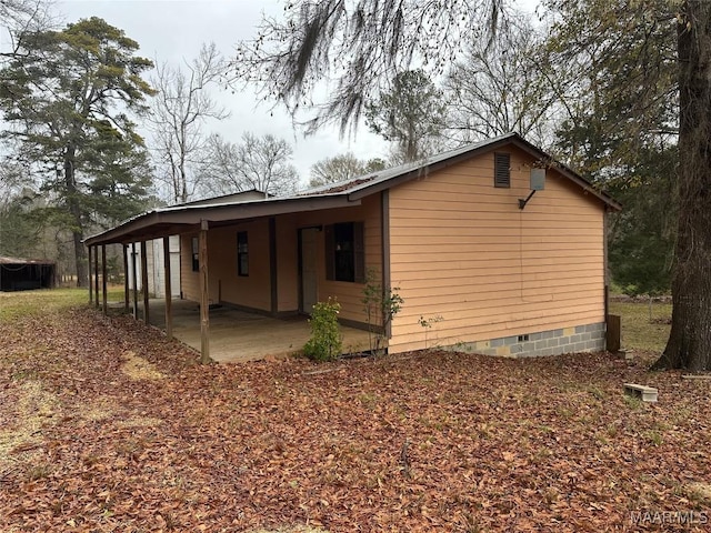 view of side of property featuring a patio area