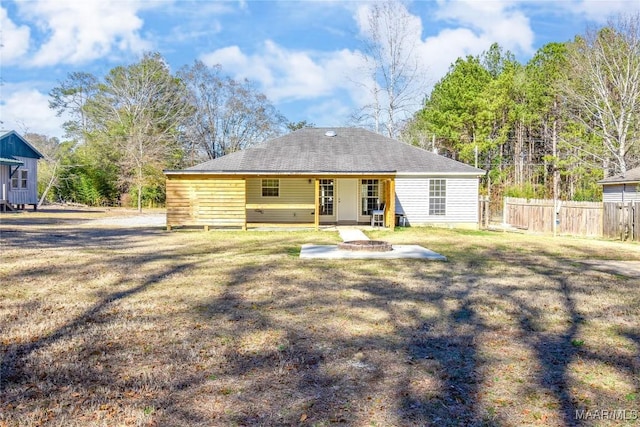 rear view of house featuring a lawn and a patio area