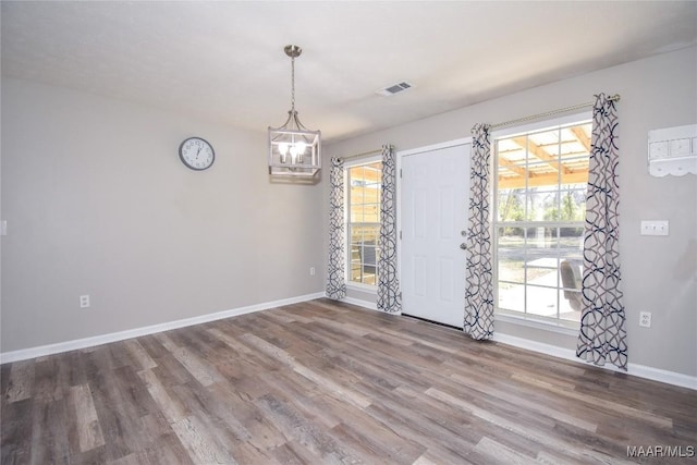 interior space featuring an inviting chandelier and wood-type flooring