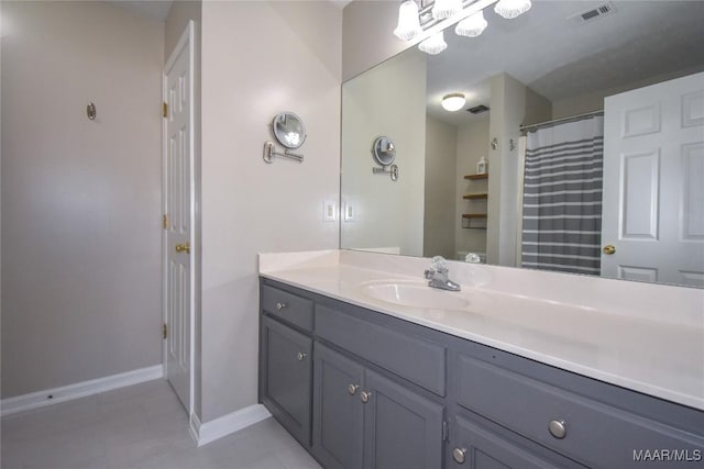 bathroom featuring tile patterned flooring, curtained shower, and vanity