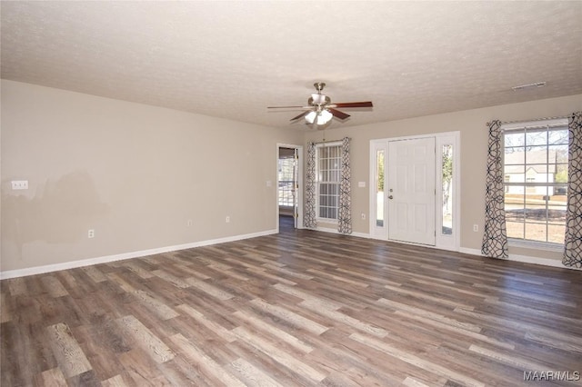 unfurnished living room featuring a textured ceiling, hardwood / wood-style floors, and ceiling fan