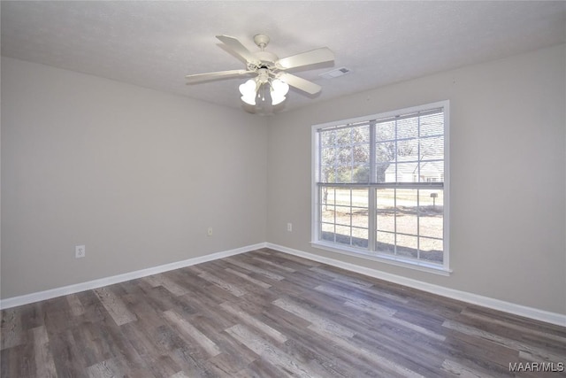 spare room with ceiling fan and dark hardwood / wood-style floors