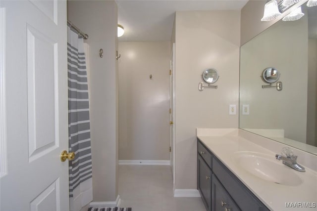 bathroom featuring tile patterned floors, walk in shower, and vanity