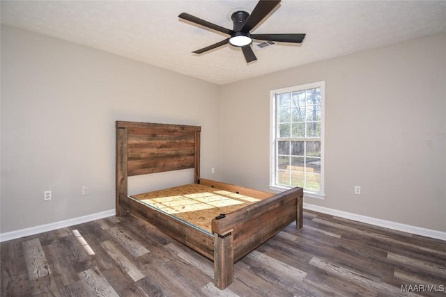 bedroom featuring dark hardwood / wood-style flooring and ceiling fan