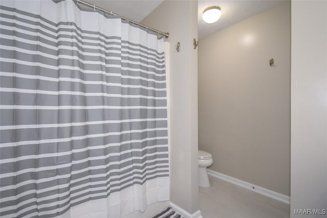 bathroom with curtained shower, tile patterned floors, and toilet