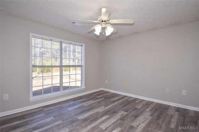 spare room with ceiling fan, a textured ceiling, and dark hardwood / wood-style floors