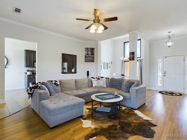 living room featuring crown molding, ceiling fan, and hardwood / wood-style flooring