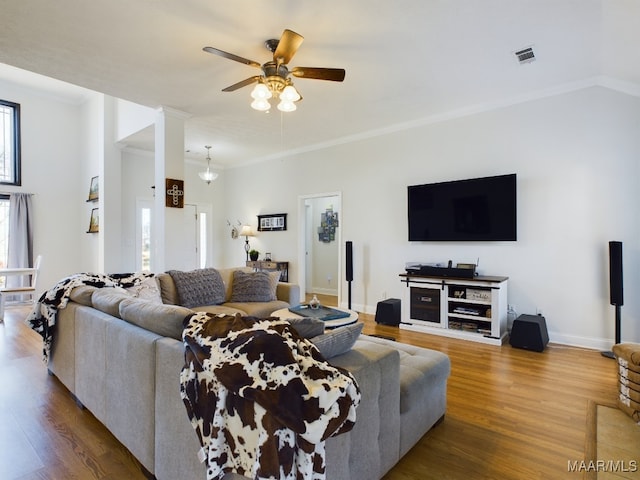 living room with ceiling fan, hardwood / wood-style floors, and ornamental molding