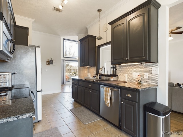 kitchen featuring ceiling fan, sink, pendant lighting, light tile patterned floors, and appliances with stainless steel finishes