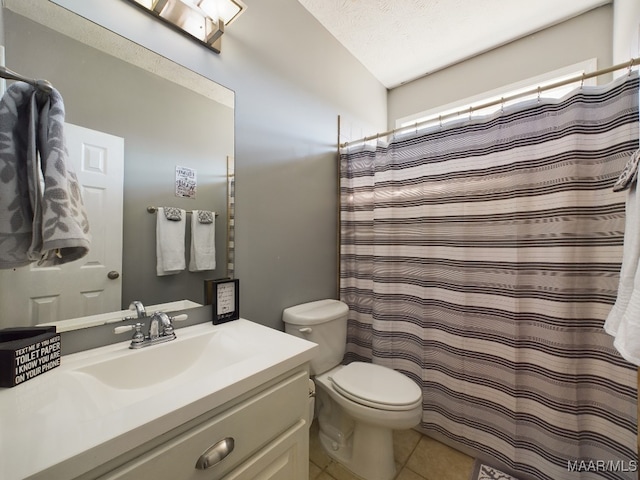 bathroom featuring vanity, tile patterned floors, a shower with shower curtain, toilet, and a textured ceiling