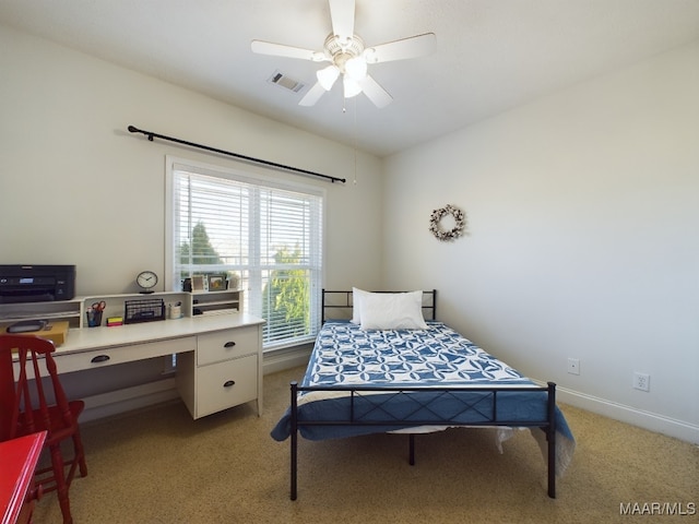 bedroom with ceiling fan and light carpet