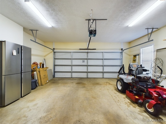 garage with stainless steel refrigerator and a garage door opener