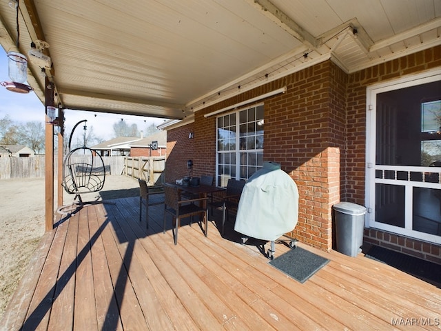 wooden deck with a grill