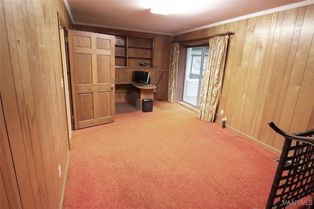 unfurnished office featuring carpet flooring, wood walls, and ornamental molding