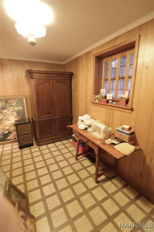dining area with crown molding and wooden walls