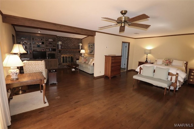 bedroom featuring crown molding, beam ceiling, a fireplace, baseboards, and wood finished floors