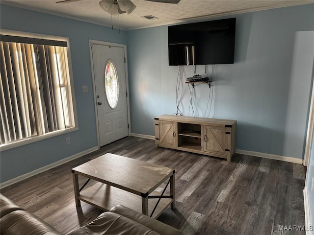 entrance foyer with ornamental molding, dark wood-type flooring, and ceiling fan