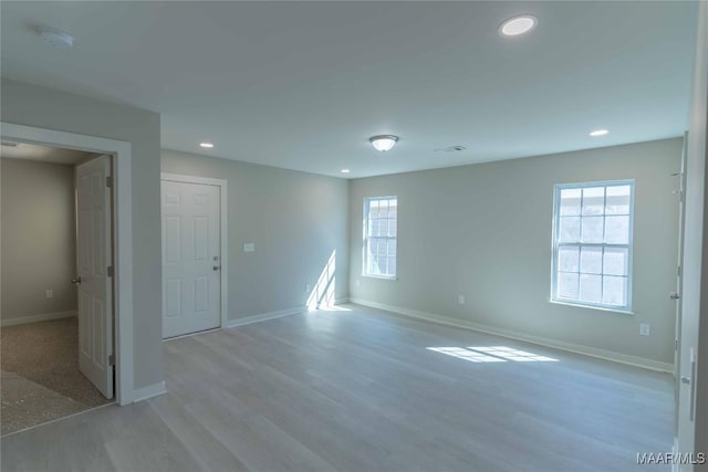 unfurnished room featuring light wood-style floors, baseboards, and recessed lighting