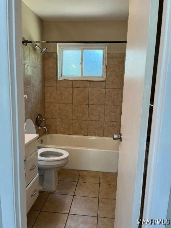 full bathroom featuring tile patterned flooring, vanity, toilet, and tiled shower / bath