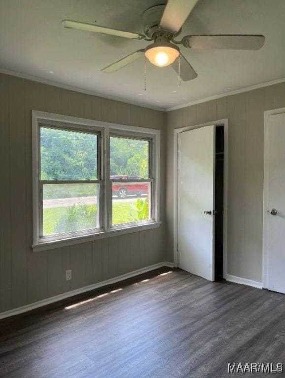 spare room with ceiling fan, crown molding, and dark hardwood / wood-style floors