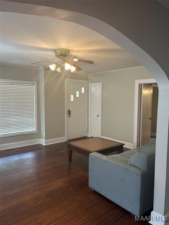 living room featuring ceiling fan, pool table, dark wood-type flooring, and ornamental molding