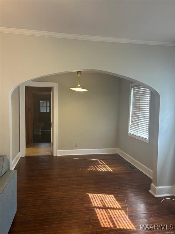 unfurnished room featuring crown molding and dark hardwood / wood-style floors