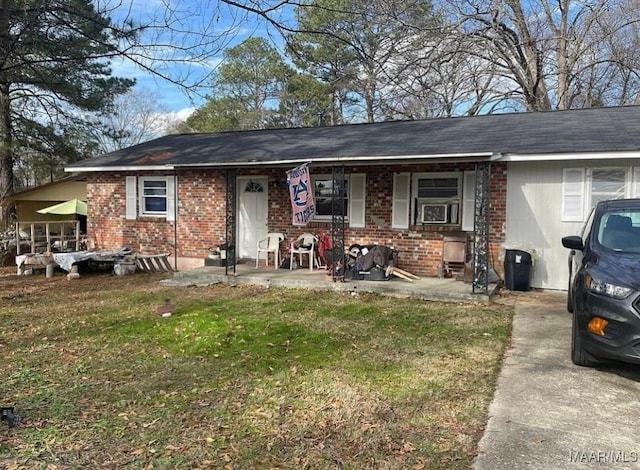 single story home with a front lawn and a porch