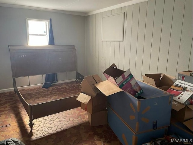 interior space featuring ornamental molding and wooden walls