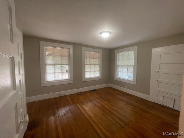 spare room with dark hardwood / wood-style floors