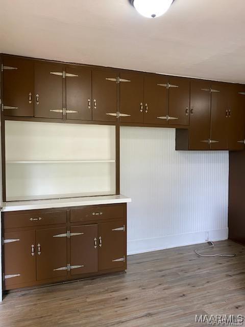 kitchen featuring dark brown cabinets and light hardwood / wood-style floors