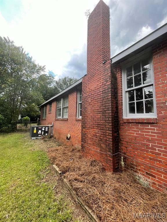 view of property exterior featuring a lawn