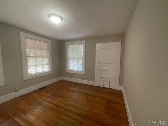 empty room featuring dark hardwood / wood-style flooring