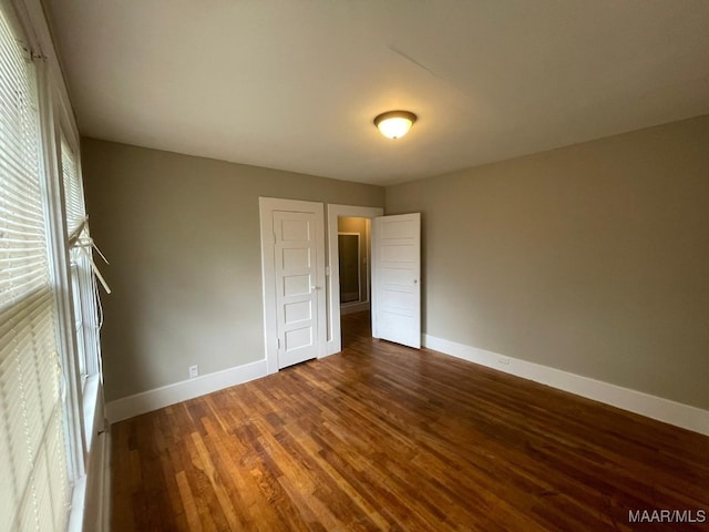 unfurnished bedroom featuring dark wood-type flooring