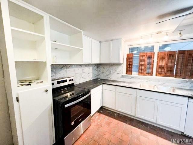 kitchen featuring decorative backsplash, white cabinetry, light stone countertops, and stainless steel electric range oven