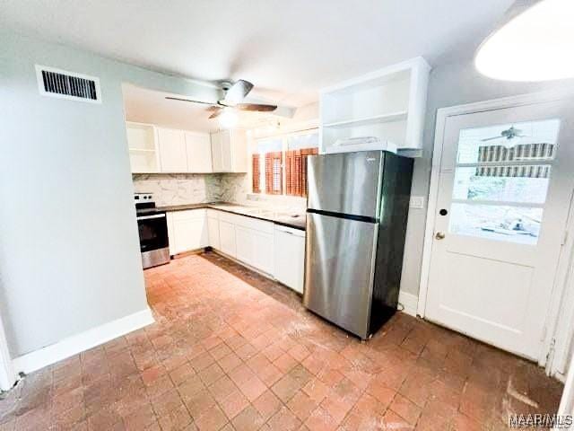 kitchen with decorative backsplash, plenty of natural light, white cabinetry, and stainless steel appliances