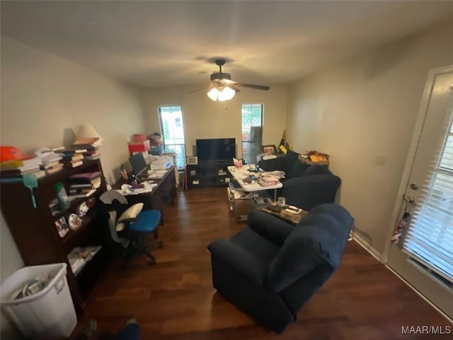 living room featuring ceiling fan and dark hardwood / wood-style flooring