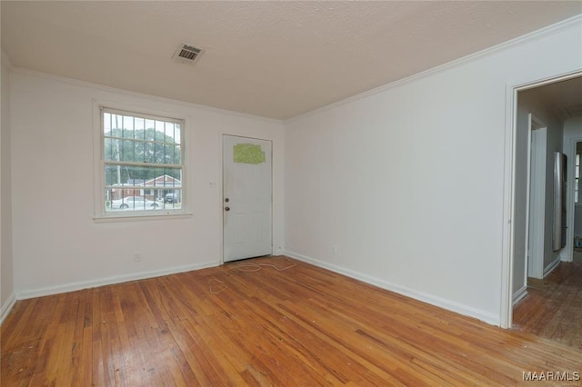 entrance foyer with light wood-type flooring and crown molding