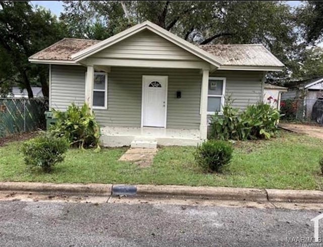 bungalow-style home featuring a porch and a front lawn