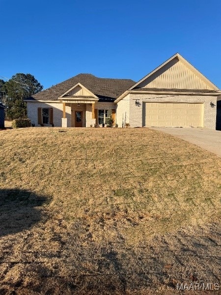 ranch-style home with a front yard and a garage